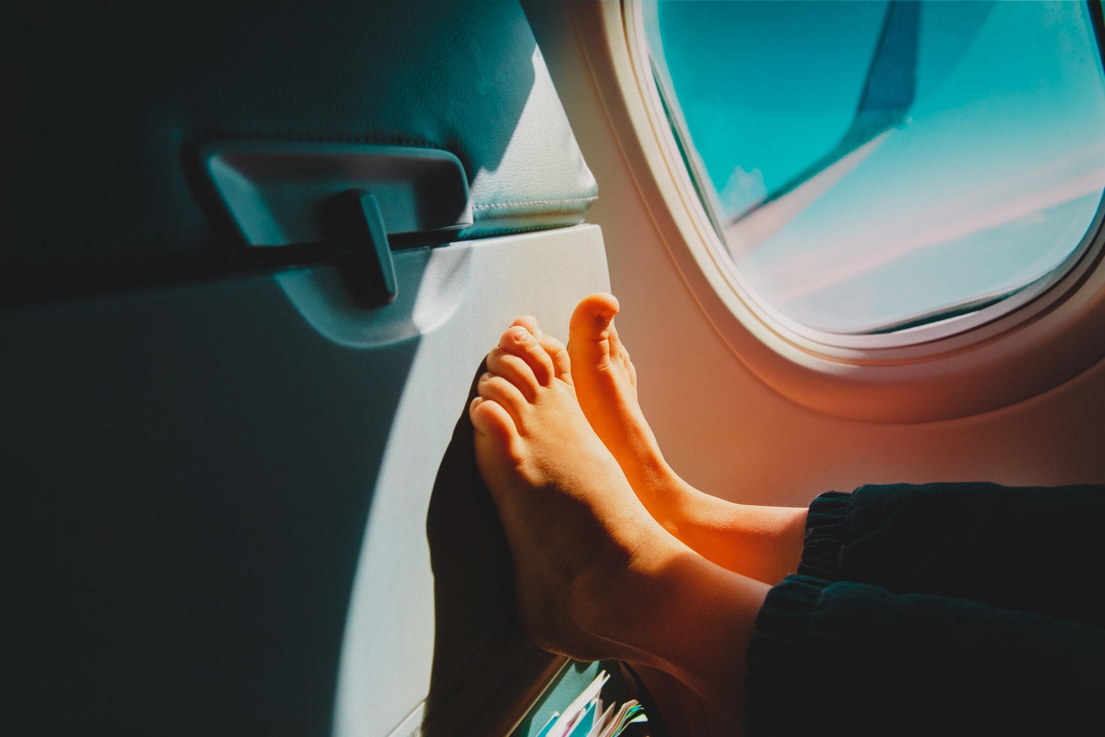 feet of little girl travel by plane child in flight